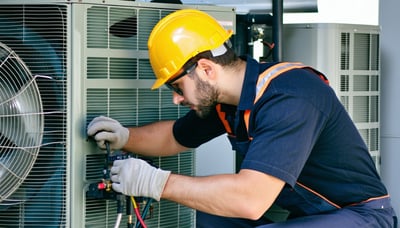 HVAC technician working on a heating and cooling system